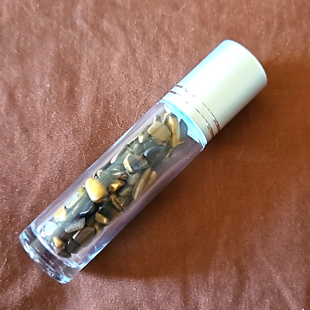 Empty glass roll-on bottle with Tiger Eye Jasper chips inside